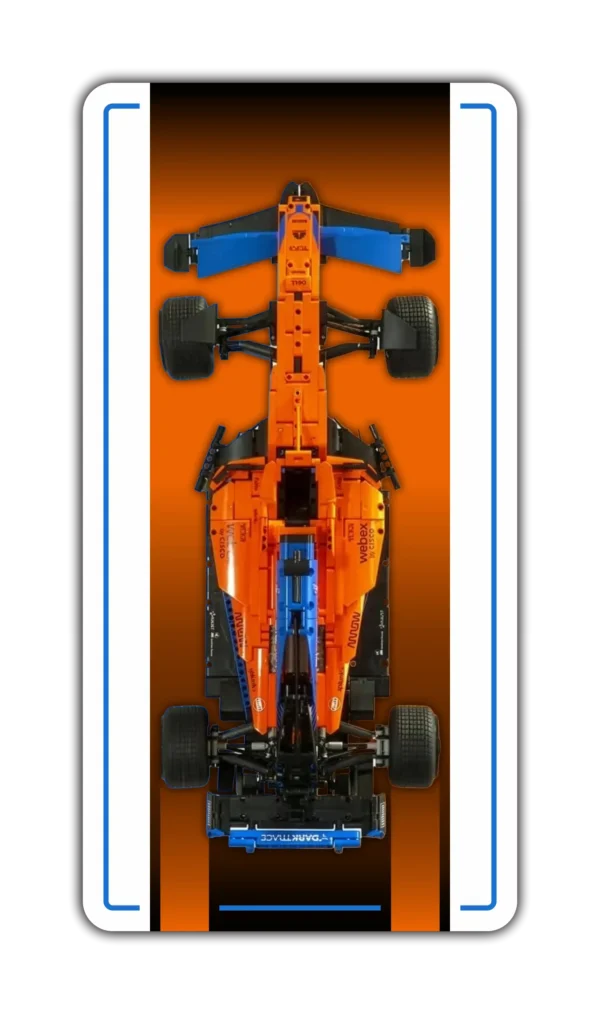 A vertical wall display mockup for a LEGO Technic model car, featuring a clean white background. In the center is a top-down view of the bright orange and blue McLaren MCL39 F1 racing car. The display panel has a rounded rectangular shape framed by a crisp, bright blue border accent line.