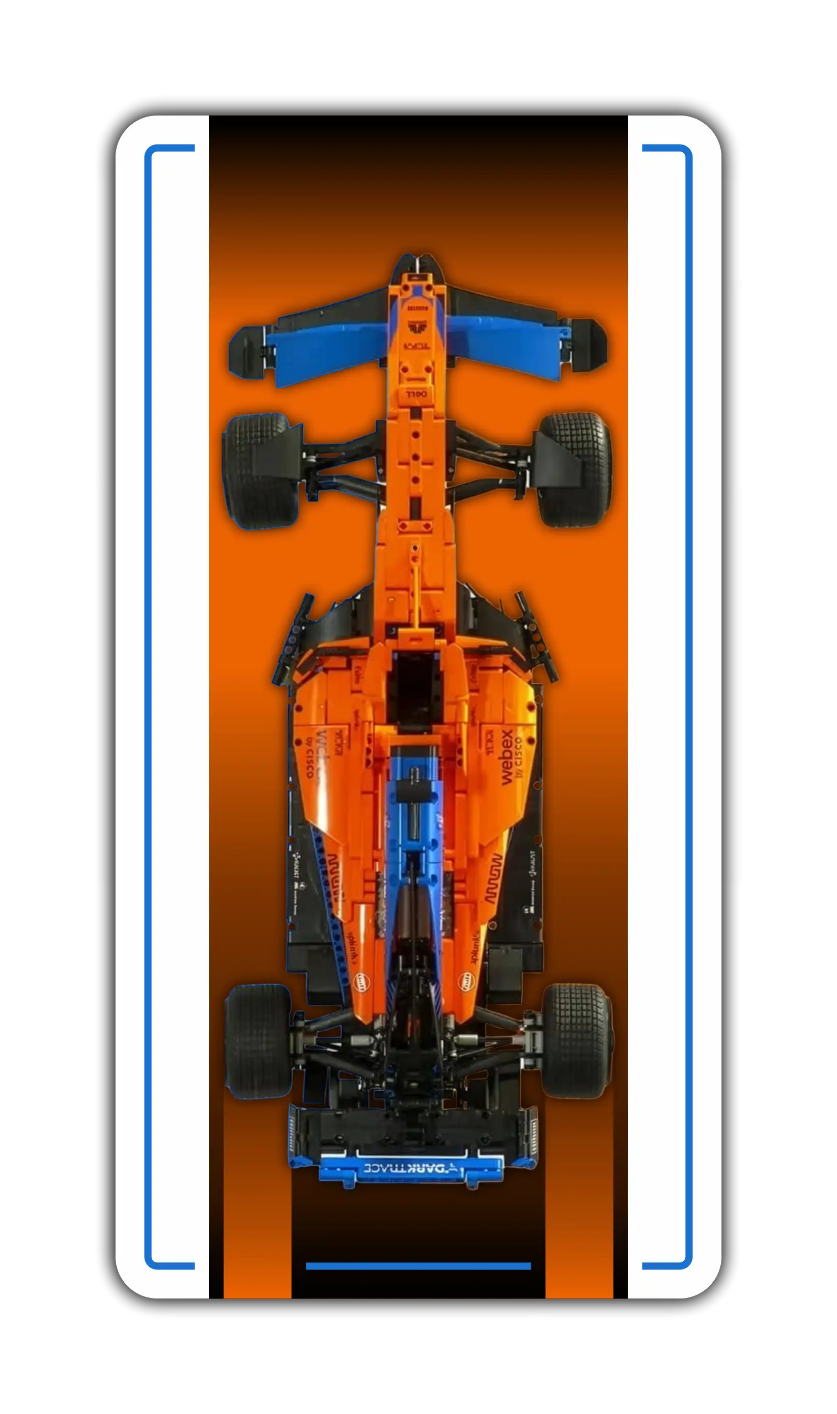 A vertical wall display mockup for a LEGO Technic model car, featuring a clean white background. In the center is a top-down view of the bright orange and blue McLaren MCL39 F1 racing car. The display panel has a rounded rectangular shape framed by a crisp, bright blue border accent line.